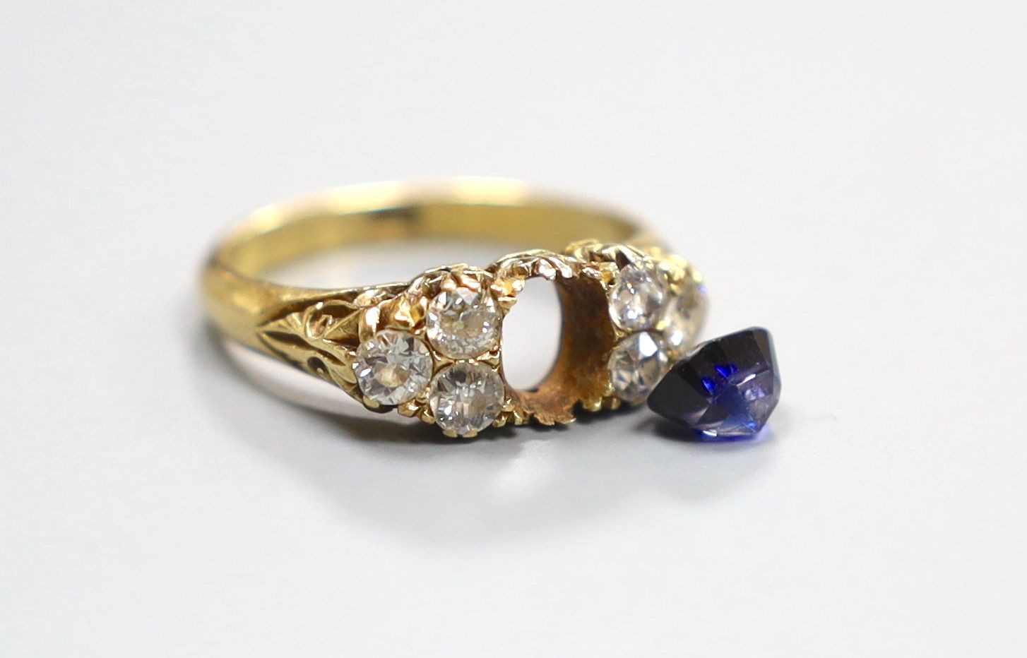 An early 20th century 18ct, single stone sapphire and six stone diamond cluster set half hoop ring, size O, gross 4.4 grams(sapphire loose).